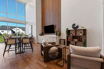 A living room with a fireplace and a large window.